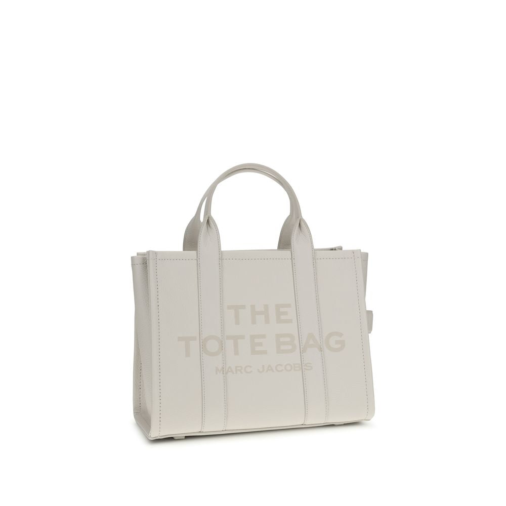 Medium Tote Handbag by Marc Jacobs for women in bos taurus calf grained leather white, patterned & monogram features a signature silhouette, showcasing a secure zipper and signature with versatile shoulder-strap, handle & adjustable-strap for a sophisticated look.