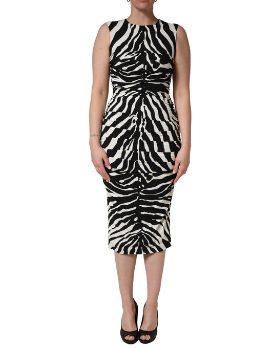 Dress by Dolce & Gabbana for women in silk viscose & calf leather black, white, zebra & print features an sultry silhouette defined by a and sleeveless, falling to an sultry midi for a sultry look.