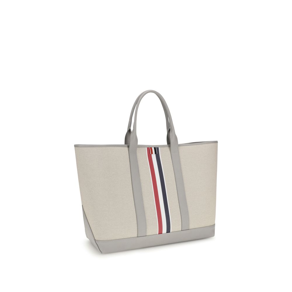 Large Tote Shoulder Bag by Thom Browne for men in cotton canvas & bos taurus calfskin leather black, gray, red, white & striped features a distinguished silhouette, showcasing a secure and distinguished with versatile handle for a distinguished finish.