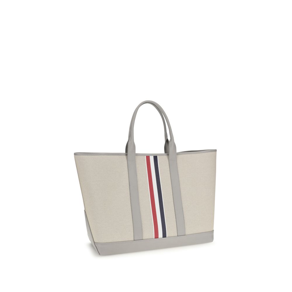 Large Tote Shoulder Bag by Thom Browne for men in cotton canvas & bos taurus calfskin leather black, gray, red, white & striped showcases a enviable silhouette, artfully detailed with a secure , organized , and versatile handle for a enviable look.