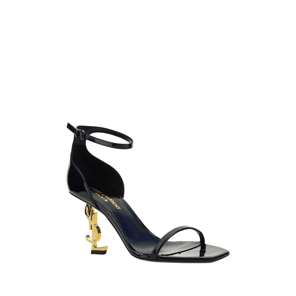 Stiletto Geometric Sandals by Saint Laurent for women in bos taurus patent calfskin leather black & gold features an architectural design from the Women's Bos Taurus Patent Calfskin Leather Stiletto Geometric Sandals collection, defined by a architectural stiletto geometric-heel and square toe style for a architectural finish.