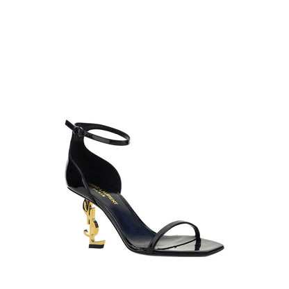 Stiletto Geometric Sandals by Saint Laurent for women in bos taurus patent calfskin leather black & gold features an architectural design from the Women's Bos Taurus Patent Calfskin Leather Stiletto Geometric Sandals collection, defined by a architectural stiletto geometric-heel and square toe style for a architectural finish.