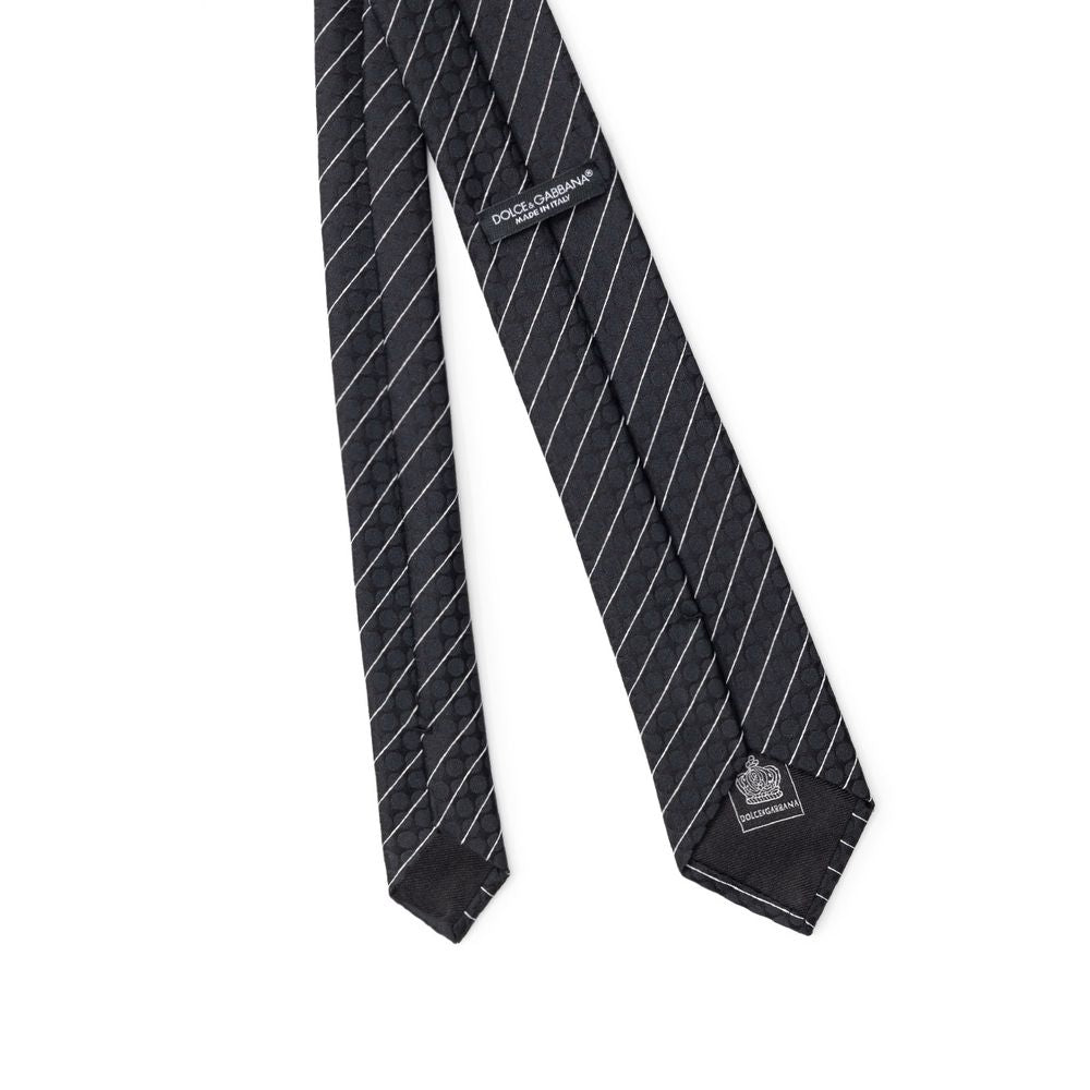 Necktie by Dolce & Gabbana for men in polyester & silk black & striped features a distinguished silhouette, artfully capturing the essence of the distinguished Polyester & Silk Necktie design for a sophisticated look.