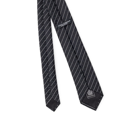 Necktie by Dolce & Gabbana for men in polyester & silk black & striped features a distinguished silhouette, artfully capturing the essence of the distinguished Polyester & Silk Necktie design for a sophisticated look.