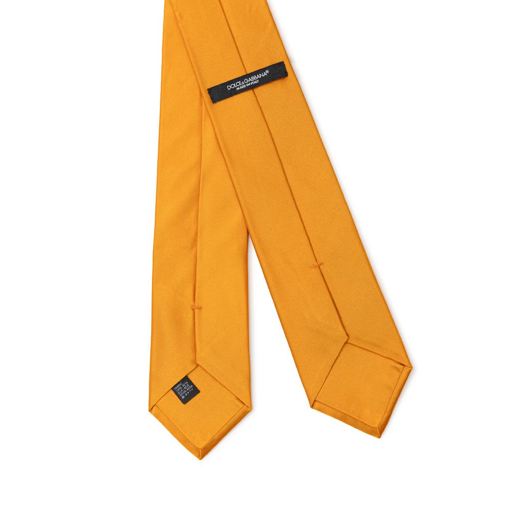Necktie by Dolce & Gabbana for men in silk orange showcases a stately silhouette, expertly detailed with a stately finish that perfectly captures the sophisticated essence of the Silk Necktie.