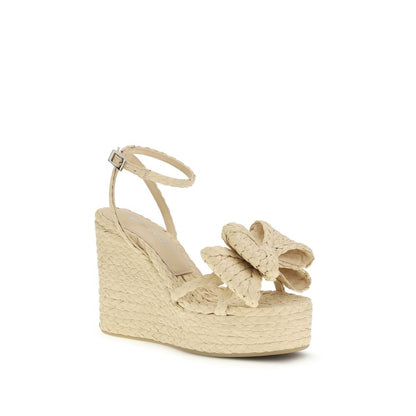 Wedge Sandals by MACH & MACH for women in raffia beige presents a sculptural silhouette, showcasing the Women's Raffia Wedge Sandals design with a sculptural wedge and for a premium look.