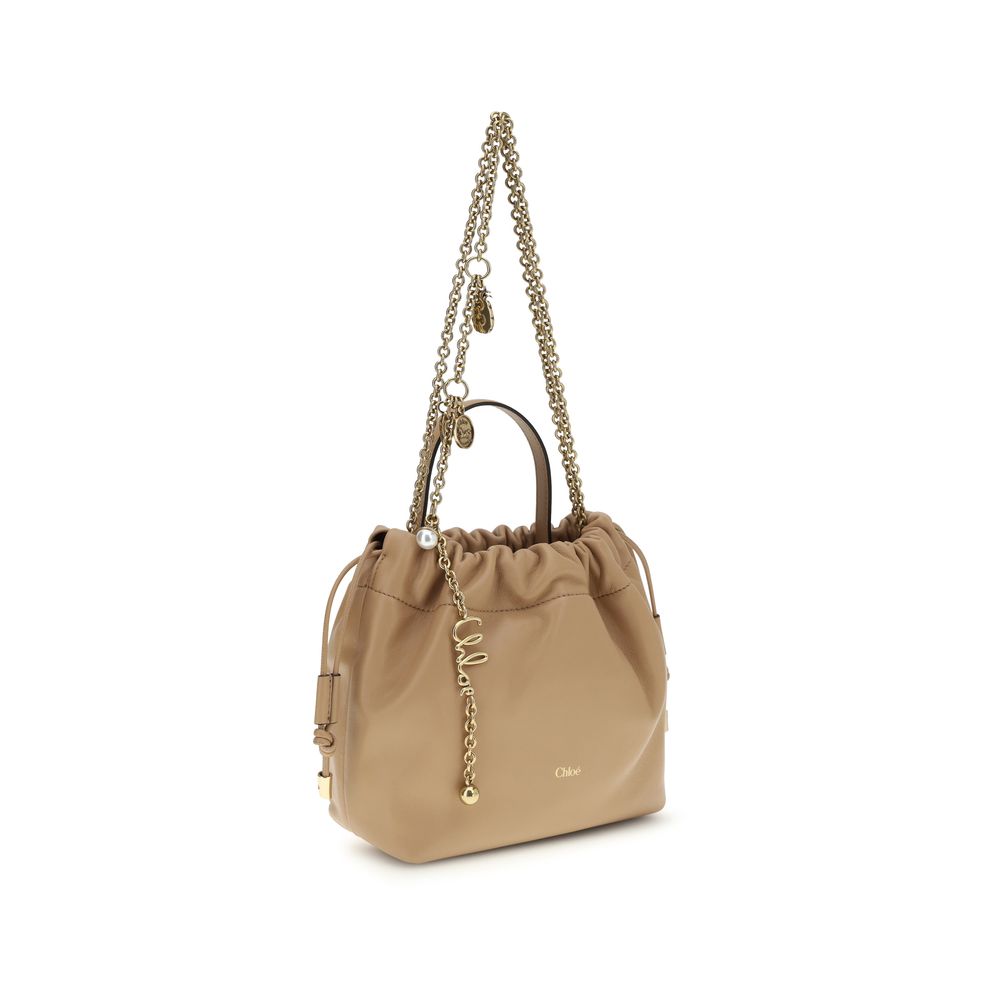 Shoulder Drawstring Bag by Chloé for women in lambskin leather beige features a distinguished silhouette, showcasing a secure drawstring and distinguished with versatile shoulder-strap & handle for a distinguished finish.