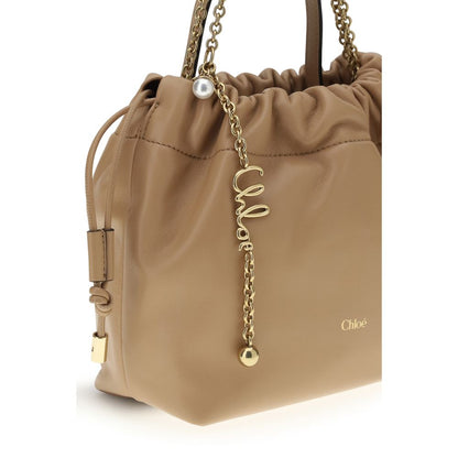 Shoulder Drawstring Bag by Chloé for women in lambskin leather beige features a enviable silhouette, showcasing a secure drawstring, ample , and enviable shoulder-strap & handle for a enviable finish.
