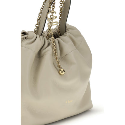 Shoulder Drawstring Bag by Chloé for women in nappa lambskin leather beige features a distinguished silhouette, showcasing a secure drawstring and distinguished with versatile shoulder-strap & handle for a distinguished finish.