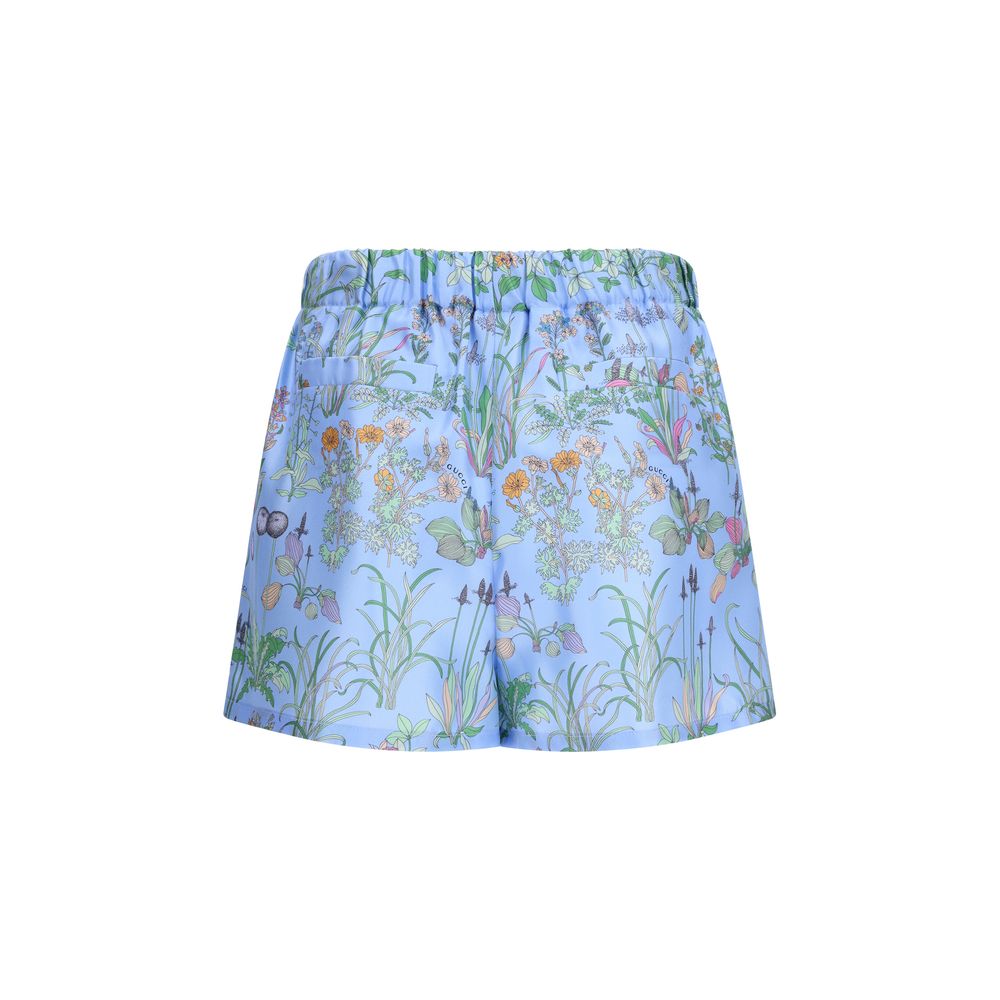 Short Trousers by Gucci for women in silk twill blue, floral & print features an sartorial luxe regular-fit and short, defined by a sartorial luxe for a sophisticated, premium silhouette.