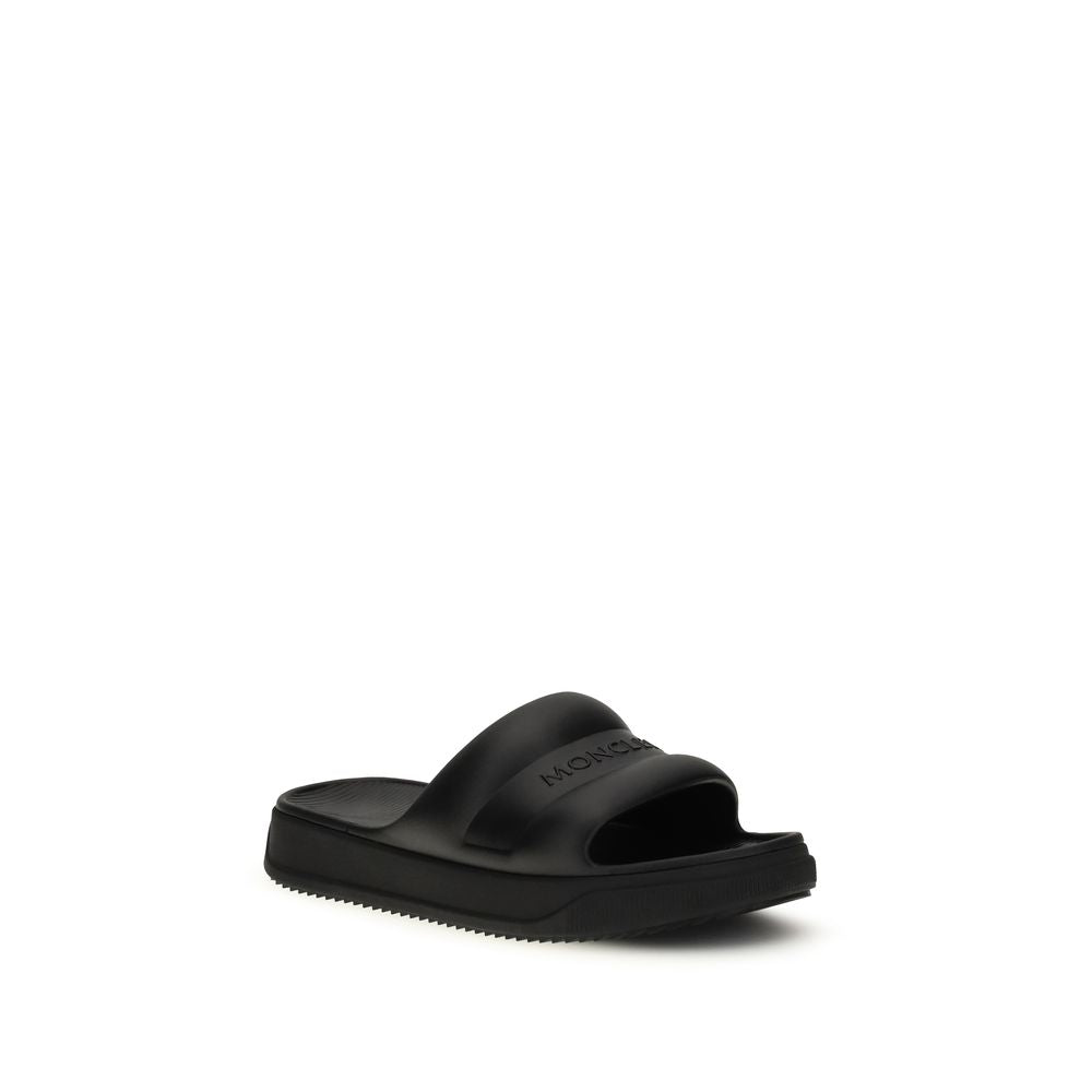 Slider Sandals by Moncler for women in rubber black features an exquisite silhouette, showcasing the exquisite Women's Rubber Slider Sandals with a and .