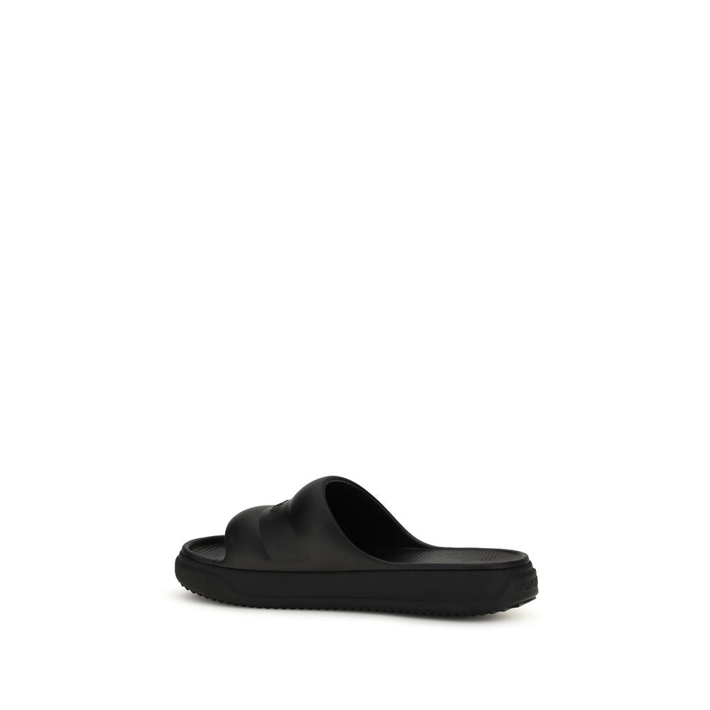 Slider Sandals by Moncler for women in rubber black presents a sculptural silhouette, showcasing the Women's Rubber Slider Sandals design with a sculptural and for a premium look.
