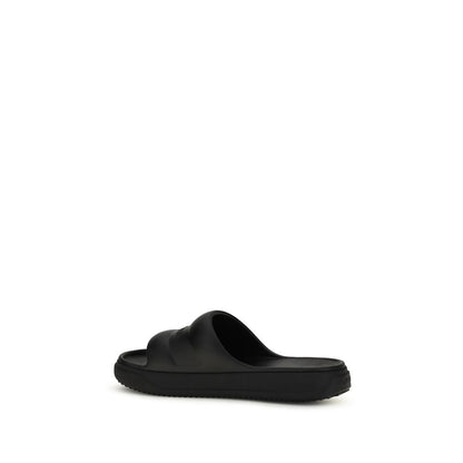 Slider Sandals by Moncler for women in rubber black presents a sculptural silhouette, showcasing the Women's Rubber Slider Sandals design with a sculptural and for a premium look.
