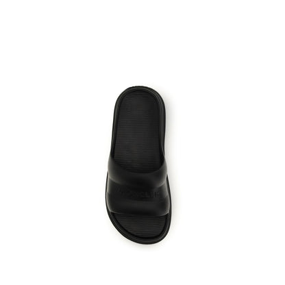 Slider Sandals by Moncler for women in rubber black features an exquisite silhouette, showcasing the exquisite Women's Rubber Slider Sandals with a and .