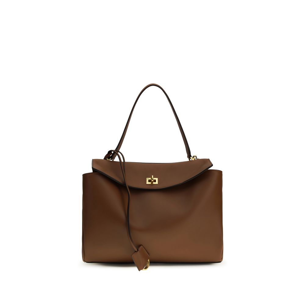 Shoulder Flap Bag by Balenciaga for women in bos taurus calf leather brown features a enviable silhouette, showcasing a secure snap & flap, ample , and enviable shoulder-strap & handle for a enviable finish.