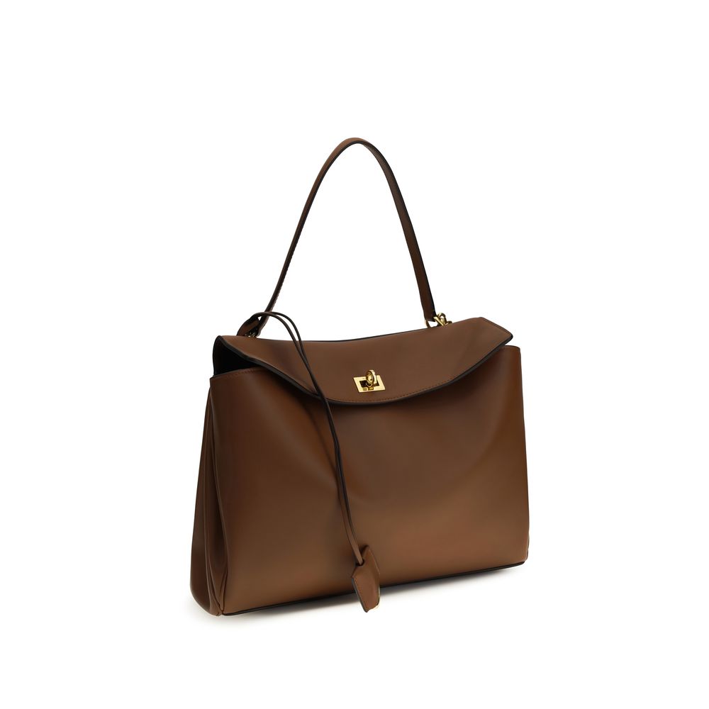 Shoulder Flap Bag by Balenciaga for women in bos taurus calf leather brown presents a versatile silhouette, showcasing a secure snap & flap and versatile with versatile shoulder-strap & handle for a sophisticated look.