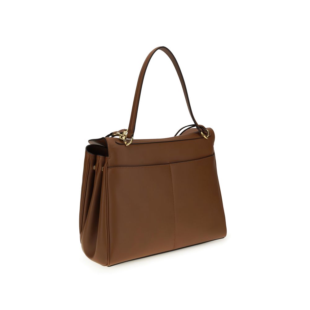 Shoulder Flap Bag by Balenciaga for women in bos taurus calf leather brown features a effortless sophistication silhouette, secured by a snap & flap with ample and versatile shoulder-strap & handle for a effortless sophistication finish.