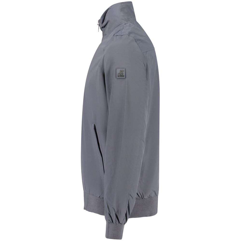 Bomber Jacket by U.S. Grand Polo for men in polyester blue features a dramatic silhouette, showcasing a sophisticated and distinctive pockets for a dramatic aesthetic.