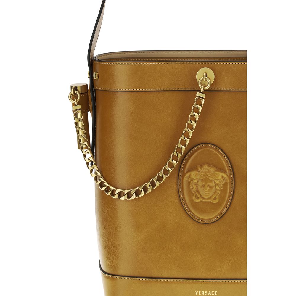 Small Shoulder Bucket Bag by Versace for women in bos taurus calf leather brown features an effortlessly chic silhouette with a secure flap, ample , and versatile shoulder-strap & handle for effortlessly chic everyday luxury.