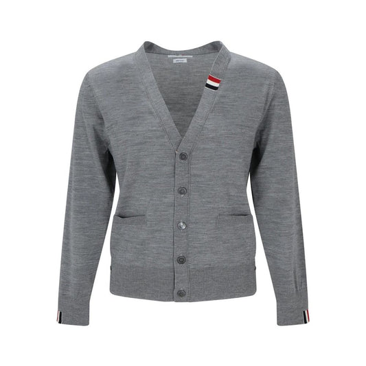Cardigan by Thom Browne for men in virgin wool gray features an crisp silhouette, showcasing a sophisticated v-neck neckline and long-sleeve detail for a truly crisp finish.