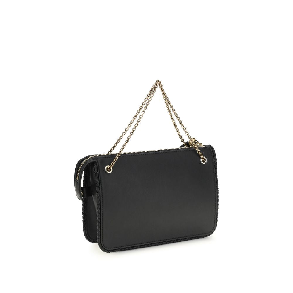 Compact Crossbody Evening Clutch Handbag by Etro for women in bos taurus grained calf leather black features a sculptural silhouette with a secure zipper, organized , and versatile crossbody-strap & handle for a sculptural finish.