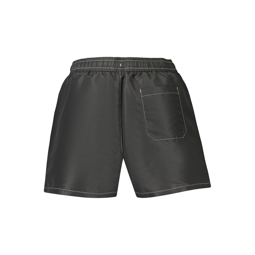 Swim Shorts by Tommy Hilfiger for men in polyester black showcases a sculptural silhouette, expertly capturing the sophisticated essence of the sculptural Men's Polyester Swim Shorts design for a premium poolside look.