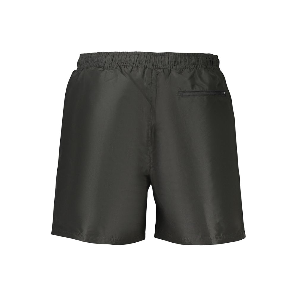 Swim Shorts by Calvin Klein for men in polyester black presents a beach chic silhouette from the Waves Men's Polyester Swim Shorts collection, showcasing a beach chic cut for a refined poolside look.