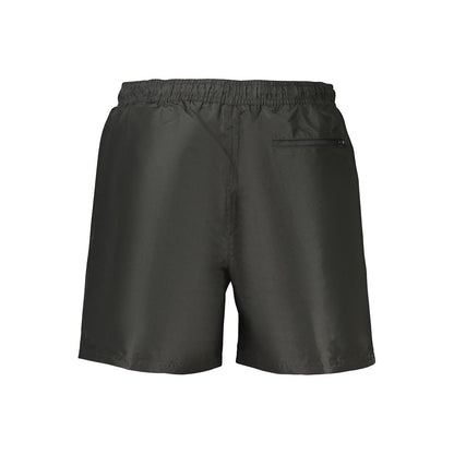 Swim Shorts by Calvin Klein for men in polyester black presents a beach chic silhouette from the Waves Men's Polyester Swim Shorts collection, showcasing a beach chic cut for a refined poolside look.