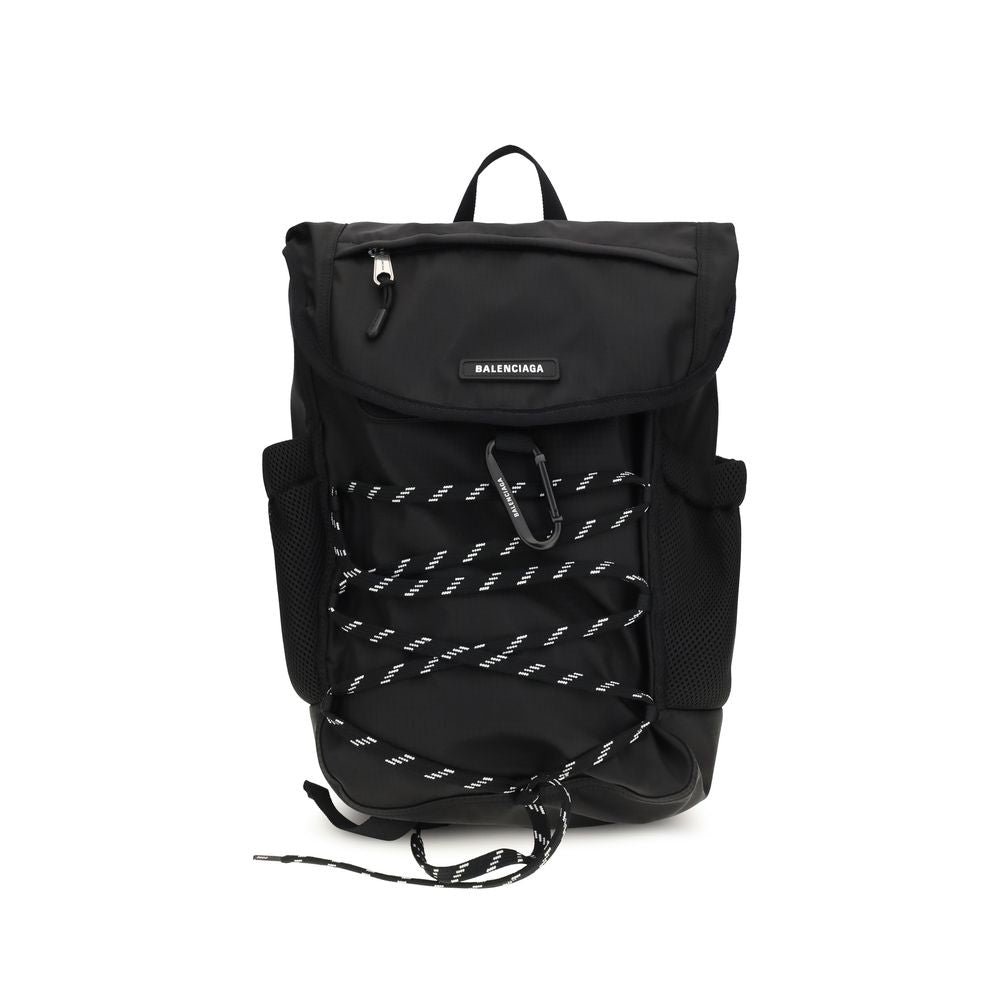 Small Flap Backpack Shoulder Bag by Balenciaga for men in nylon black features an effortlessly chic silhouette with a secure flap & zipper, ample external-pockets, and versatile shoulder-strap, handle, backpack-strap & adjustable-strap for effortlessly chic everyday luxury.