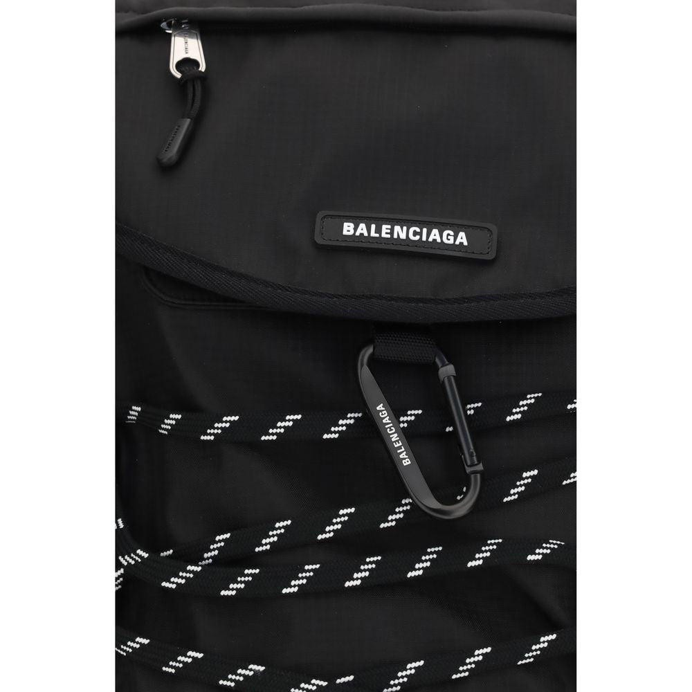 Small Flap Backpack Shoulder Bag by Balenciaga for men in nylon black features a distinguished silhouette, showcasing a secure flap & zipper and distinguished external-pockets with versatile shoulder-strap, handle, backpack-strap & adjustable-strap for a distinguished finish.