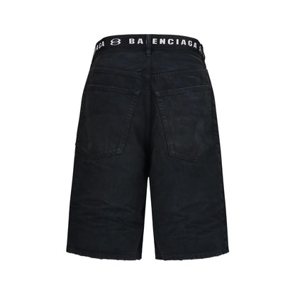 Denim Shorts by Balenciaga for men in denim cotton black & signature features an utilitarian chic regular-fit with a short and mid rise, creating a utilitarian chic silhouette perfect for elevated casual styling.