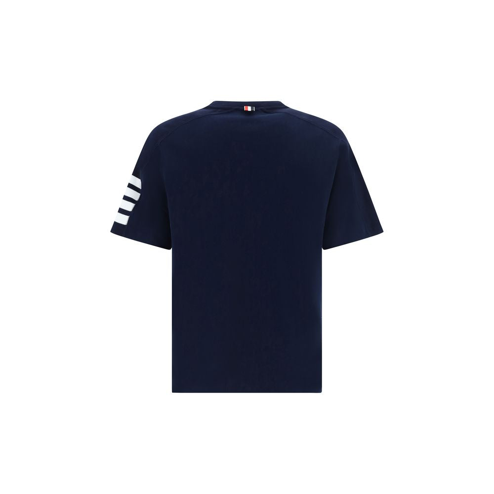 T-Shirt by Thom Browne for men in cotton blue, monogram & striped features an edgy silhouette, meticulously detailed with a sophisticated and crew neckline for a truly edgy finish.