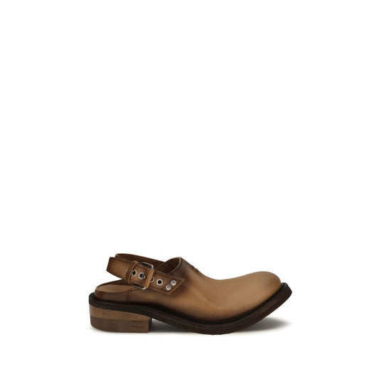 Mules Flat Shoes by Miu Miu for women in bos taurus calf leather brown presents a effortless chic silhouette, showcasing the Women's Bos Taurus Calf Leather Mules Flat Shoes design with a effortless chic and round toe style for a sophisticated look.