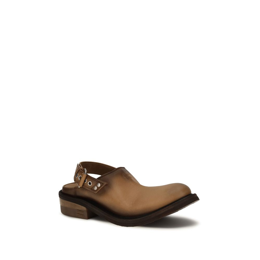 Mules Flat Shoes by Miu Miu for women in bos taurus calf leather brown presents a impeccable silhouette as Women's Bos Taurus Calf Leather Mules Flat Shoes, artfully designed with a and a impeccable round toe style for a refined, upscale finish.