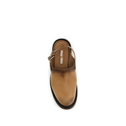 Mules Flat Shoes by Miu Miu for women in bos taurus calf leather brown showcases a enchanting silhouette as part of the Women's Bos Taurus Calf Leather Mules Flat Shoes collection, defined by a enchanting round toe style and for a enchanting look.