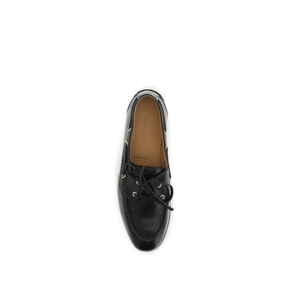 Flat Boat Loafer Slip-On Shoes by Bally for women in bos taurus calf & buffalo leather black & gold showcases a timeless silhouette from the Women's Bos Taurus Calf & Buffalo Leather Flat Boat Loafer Slip-On Shoes collection, featuring a timeless flat and for a timeless finish.