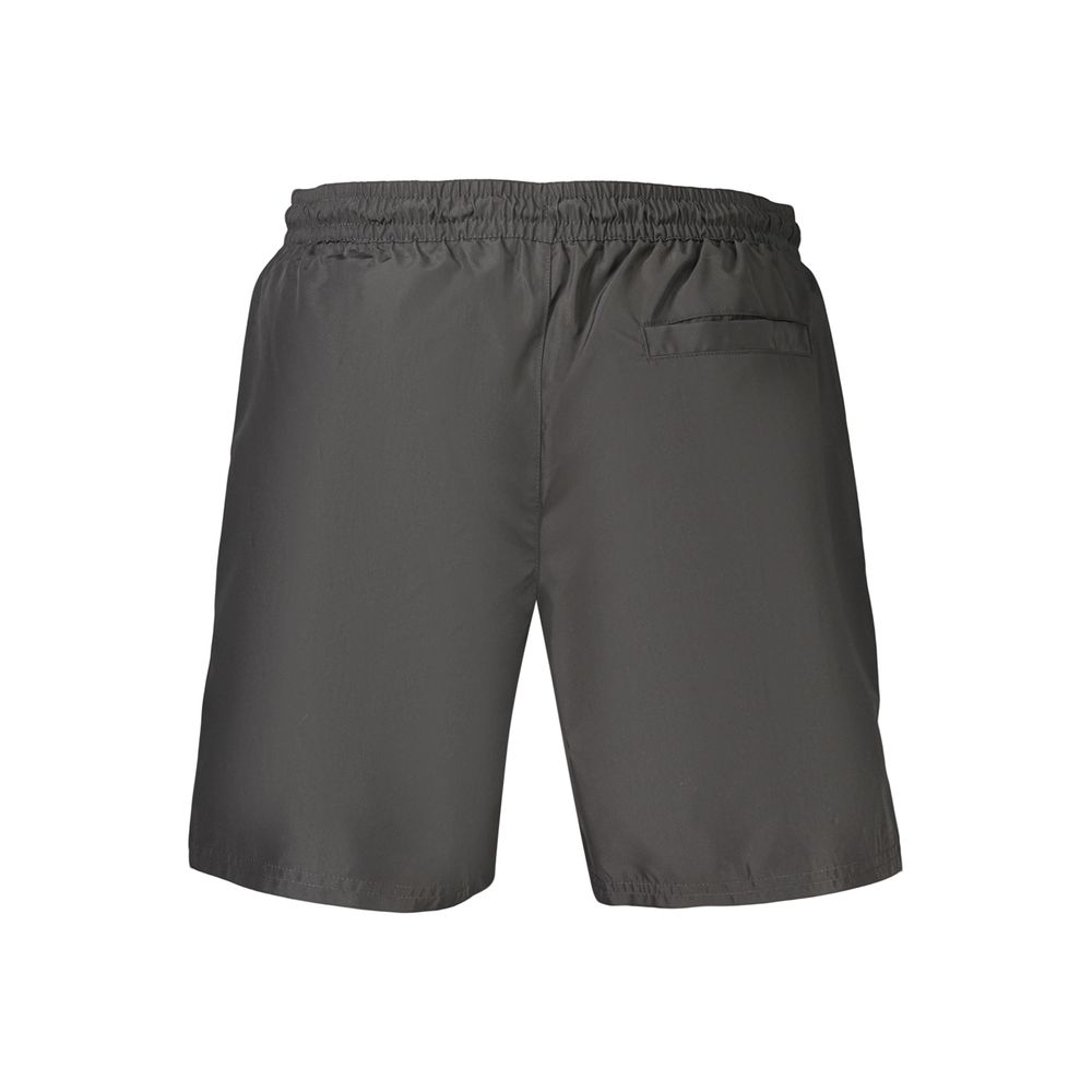 Swim Shorts by Calvin Klein for men in polyester black features a resort ready silhouette, perfectly capturing the resort ready aesthetic of Waves Men's Polyester Swim Shorts with a resort ready finish.