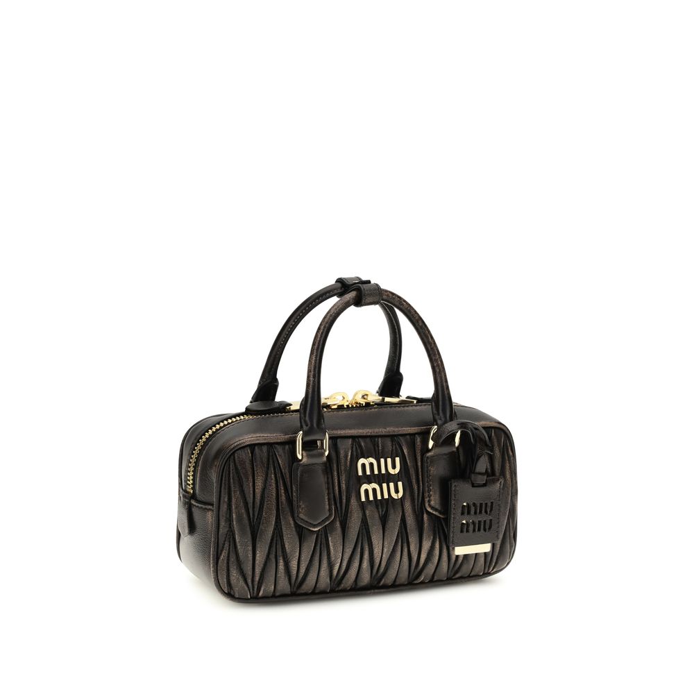Quilted Satchel Pouch Handbag by Miu Miu for women in nappa lambskin leather & cotton brown, gold & patterned presents a ornamental silhouette, showcasing a secure zipper, ample , and versatile shoulder-strap, adjustable-strap & handle for a ornamental finish.