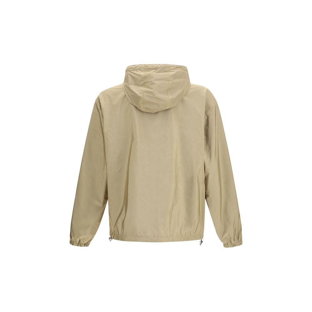 This Hooded Puffer Jacket by Prada for men in nylon beige & signature exhibits a edgy silhouette, meticulously detailed with functional pockets, hooded, insulated & windproof and a edgy hooded neckline for a edgy finish.