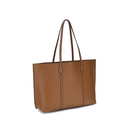 This Small Tote Clutch Handbag by Tory Burch for women in bos taurus grained calf leather and brown & gold presents a sculptural silhouette featuring a secure , ample , and versatile handle for a sculptural finish.