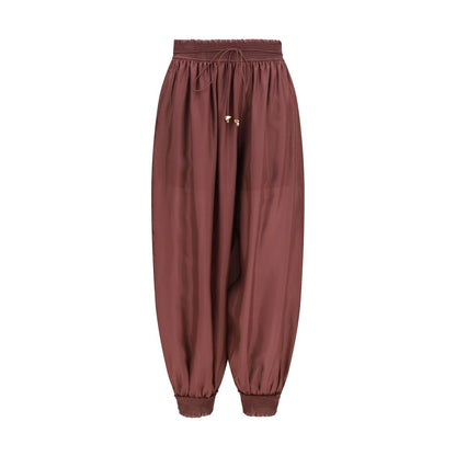 Herem Pants by Zimmermann for women in silk bordeaux features an utilitarian-chic silhouette, showcasing a utilitarian-chic tapered-leg & regular-fit with a long cut and mid rise for a refined look.