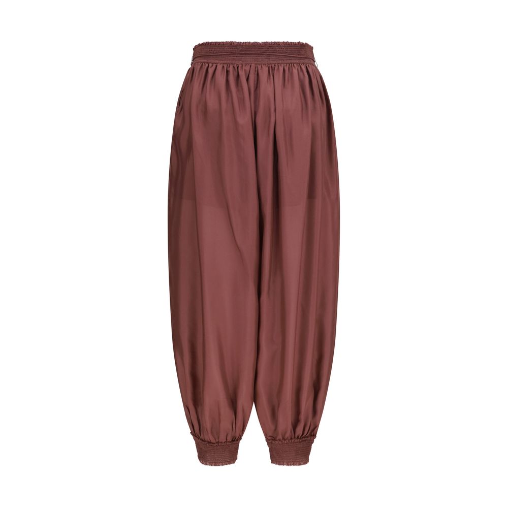 Herem Pants by Zimmermann for women in silk bordeaux features a modern silhouette, showcasing a modern tapered-leg & regular-fit with a long and mid rise for a refined finish.