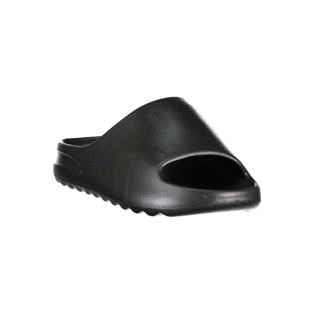 Slider Sandals by Norway 1963 for women in polyurethane and black presents a sculptural silhouette, showcasing the signature style of the Women's Polyurethane Slider Sandals with a sculptural and sculptural .