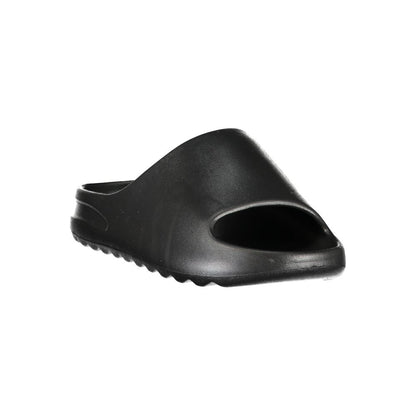 Slider Sandals by Norway 1963 for women in polyurethane and black presents a sculptural silhouette, showcasing the signature style of the Women's Polyurethane Slider Sandals with a sculptural and sculptural .
