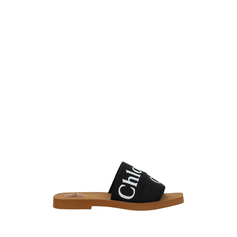 Flat Sandals by Chloé for women in polyester cotton & linen black & signature presents a sculptural silhouette, showcasing the Woody Women's Polyester Cotton & Linen Flat Sandals design with a sculptural flat and square toe style for a premium look.