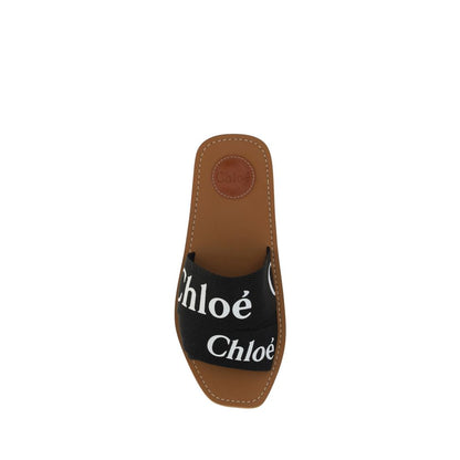 Flat Sandals by Chloé for women in polyester cotton & linen and black & signature presents a captivating silhouette, showcasing the signature style of the Woody Women's Polyester Cotton & Linen Flat Sandals with a captivating flat and captivating square toe style.