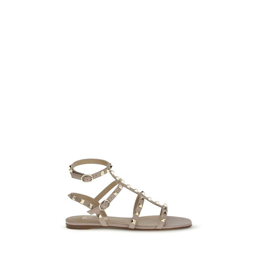 Flat Sandals by Valentino Garavani for women in bos taurus calf leather pink presents a sculptural silhouette, showcasing the Rockstud Women's Bos Taurus Calf Leather Flat Sandals design with a sculptural flat and for a premium look.