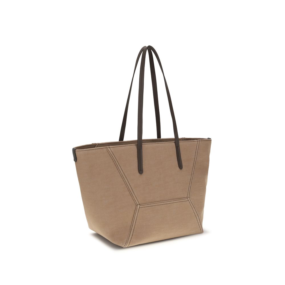 This Shoulder Trapeze Handbag by Brunello Cucinelli for women in poly cotton canvas & leather and beige presents a sculptural silhouette featuring a secure , ample , and versatile shoulder-strap & handle for a sculptural finish.