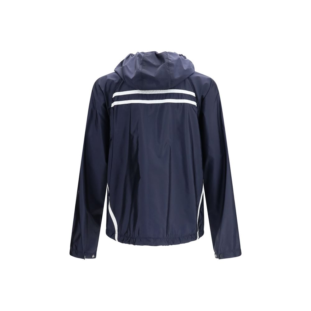 Hooded Windbreaker Jacket by Prada for men in nylon blue presents a resilient silhouette, artfully detailed with a sophisticated hooded neckline and functional pockets, hooded & windproof for a resilient finish.