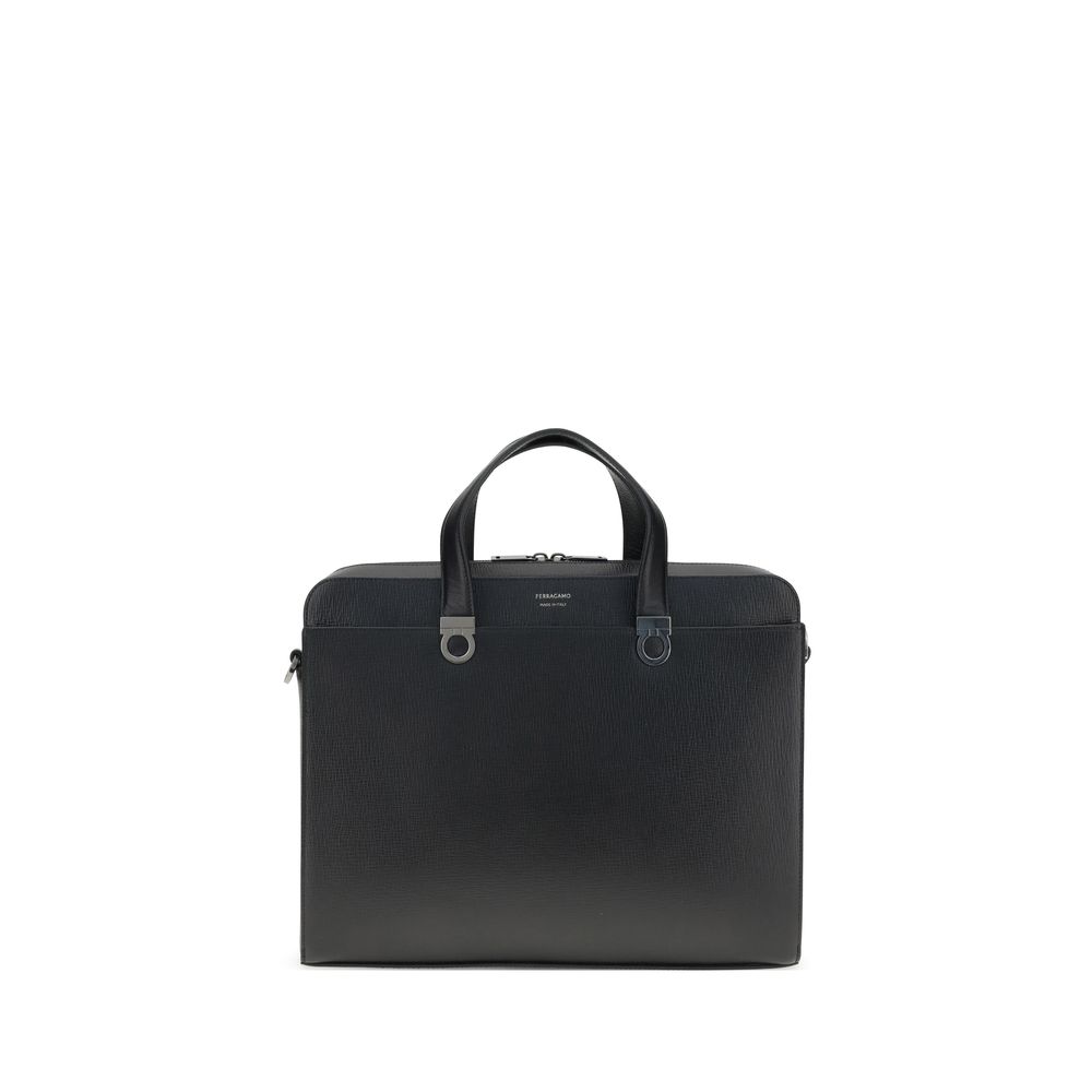 Large Briefcase by Ferragamo for men in bos taurus calf leather black & jacquard features a utilitarian chic Gancini Ribbon Bos Taurus Calf Leather Large Briefcase design with a secure magnetic, utilitarian chic external-pockets, and versatile shoulder-strap, adjustable-strap & handle for a sophisticated look.